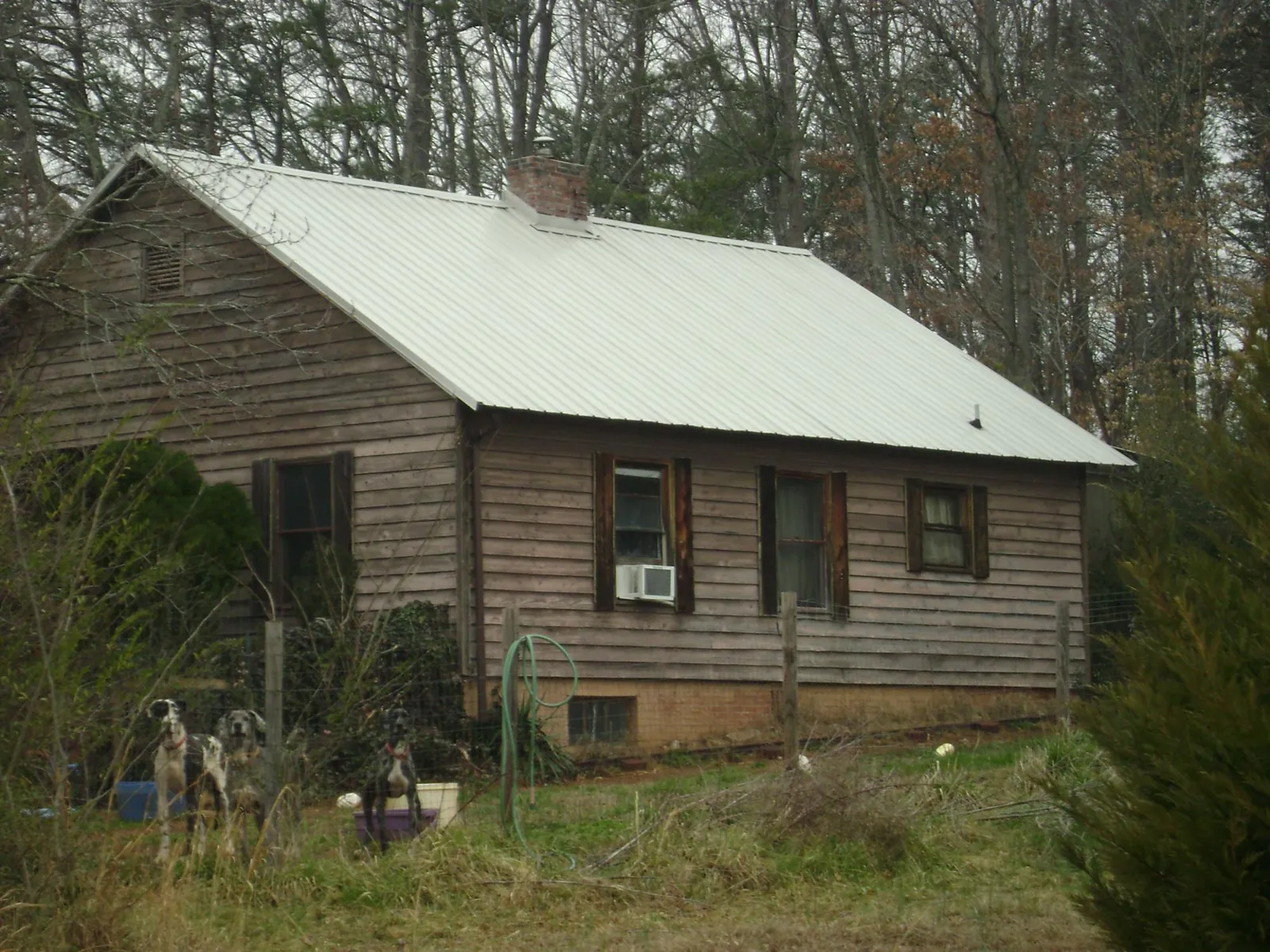 White metal roof on an old wood sided farmhouse, from a Metal Roof Installation job in Ocean City